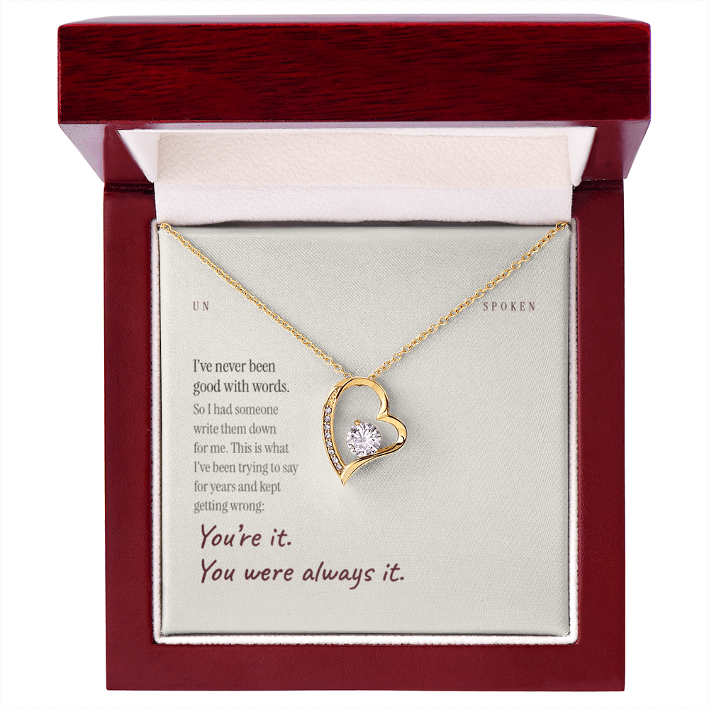 The printed message card and yellow gold heart necklace inside the mahogany style luxury box