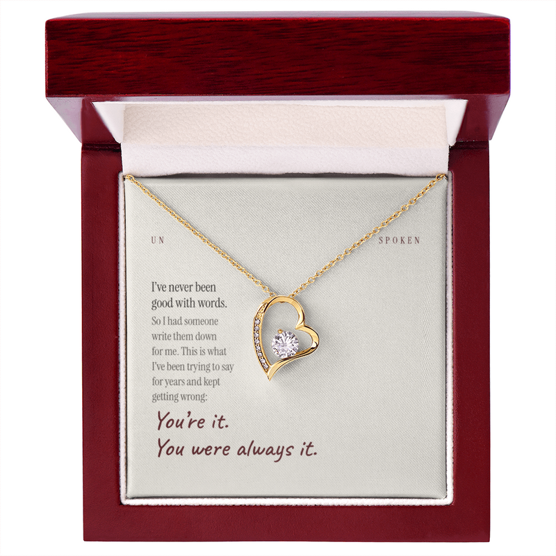 The mahogany style luxury box open, with the LED spotlight on the necklace