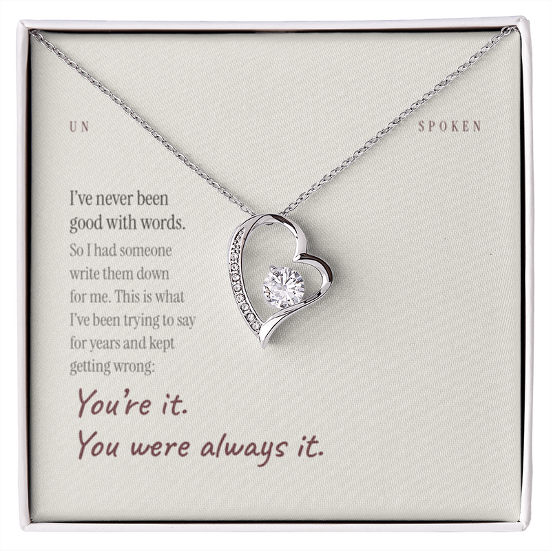 The printed message card with the heart necklace resting on it